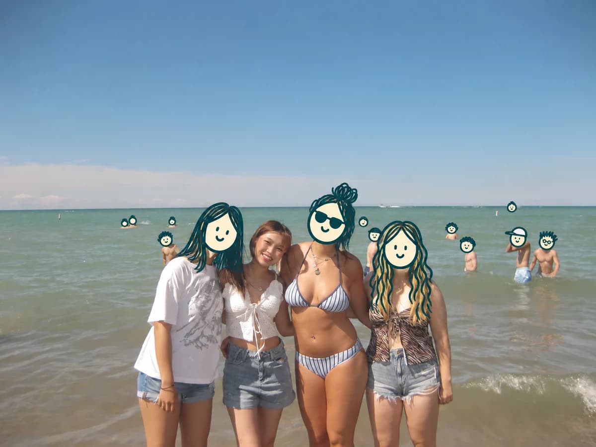 Chloe and friends at the beach, with cartoon doodles covering other faces
