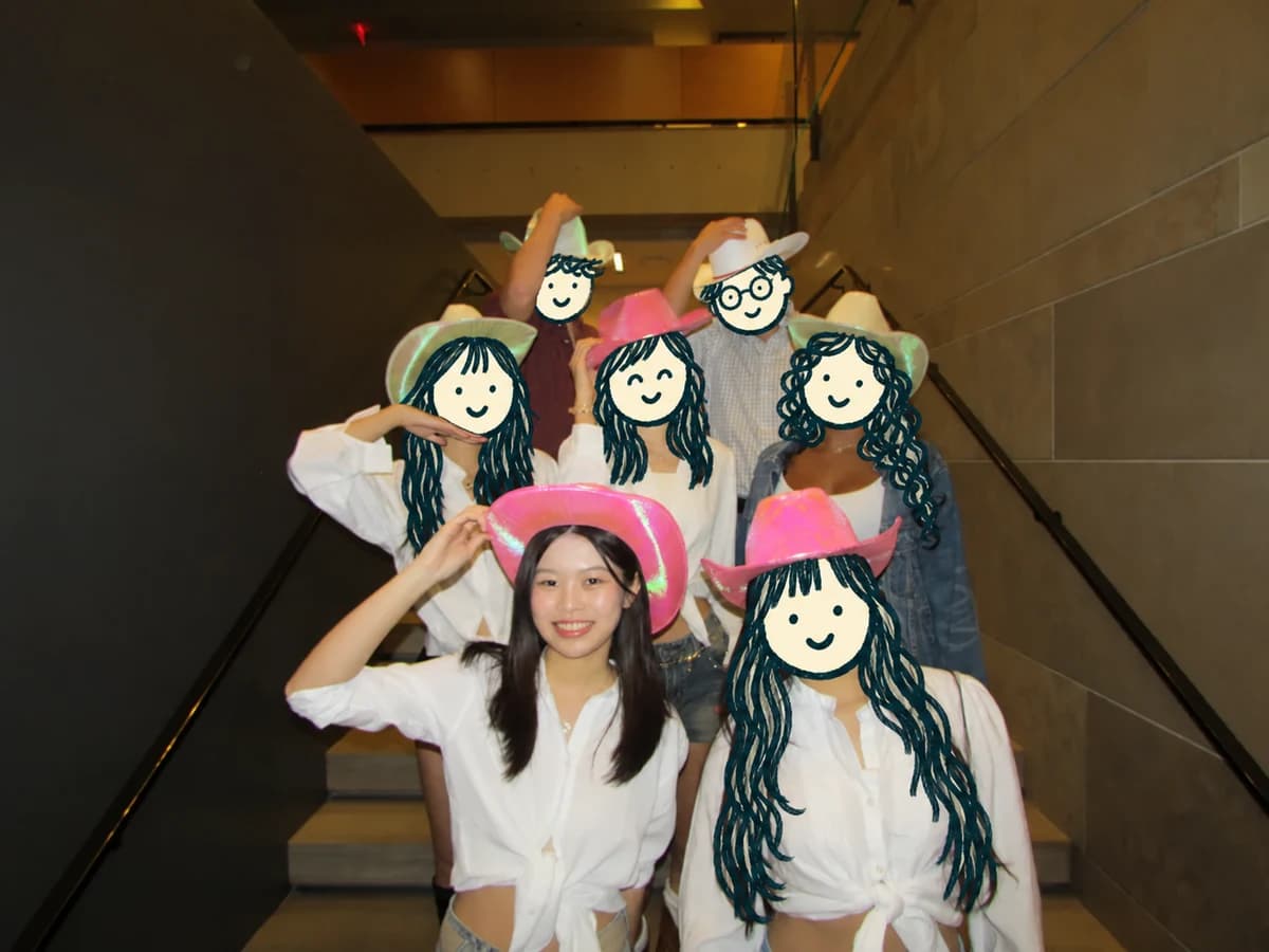 Chloe and friends in colorful cowboy hats, with cartoon doodles covering friends’ faces